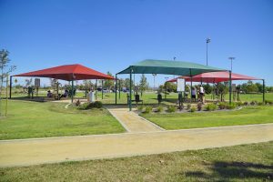 outdoor fitness equipment under three shade structures