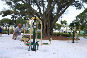 A man using 4-Person Leg press at Tropical Park