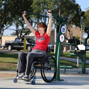 A woman in a wheelchair exercising on the Accessible Lat Pull