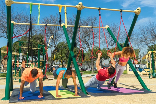 A group of people exercising on the X-Rig