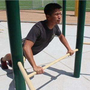 A man using Assisted Push-Up Bar