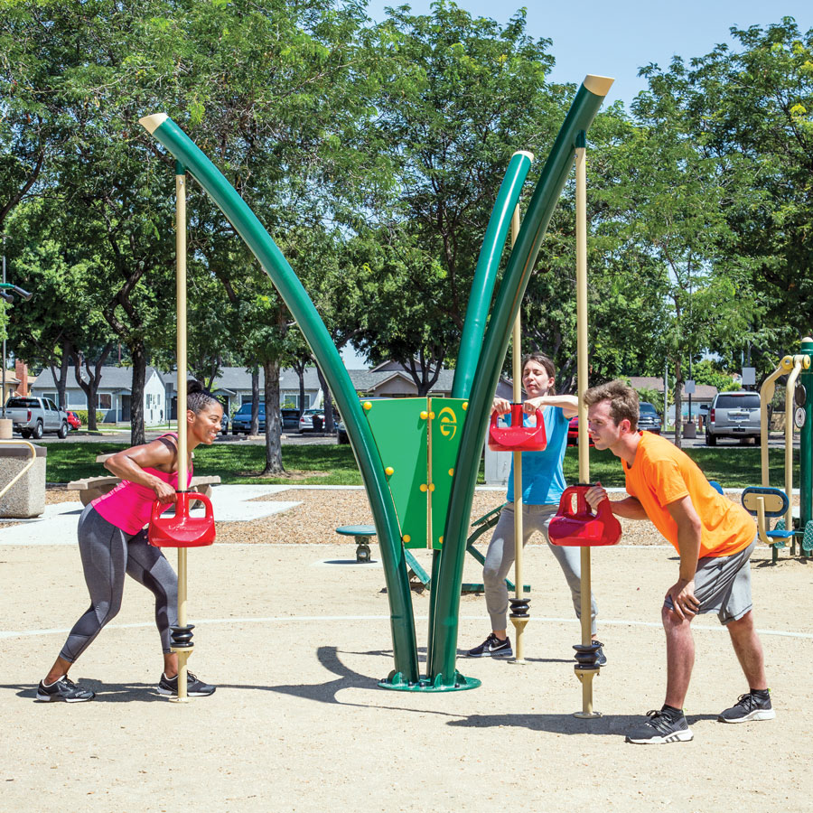 Two women and a man exercising with the 3-Person Kettlebell Station