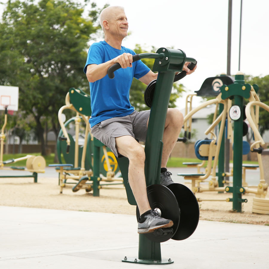 A Man exercising on the upright bike