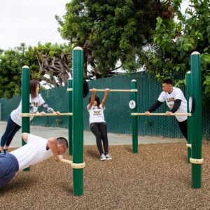 Four students using the multi-level bars