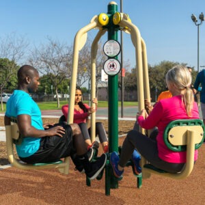 A man and two women using the 4-person leg press