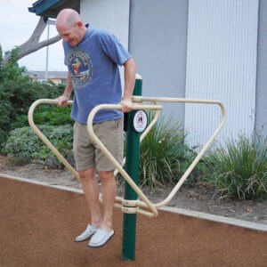 A man using the 2-Person Dip Bars