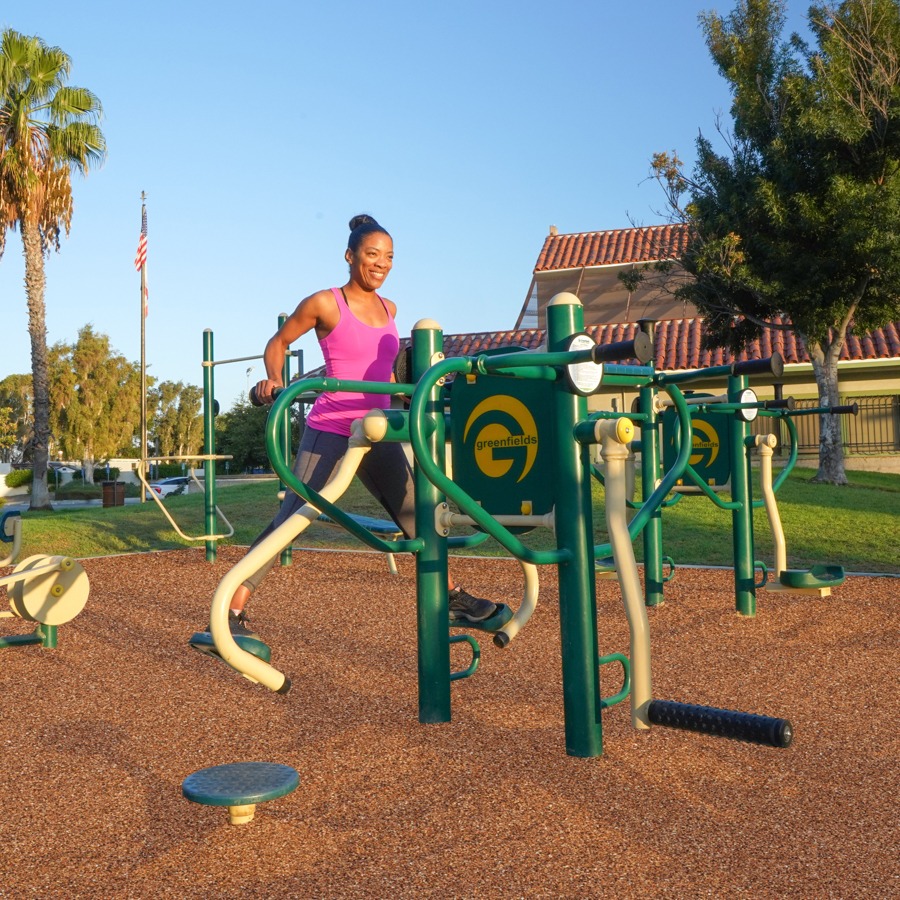 A woman exercising on a 4-Person Lower Body Combo