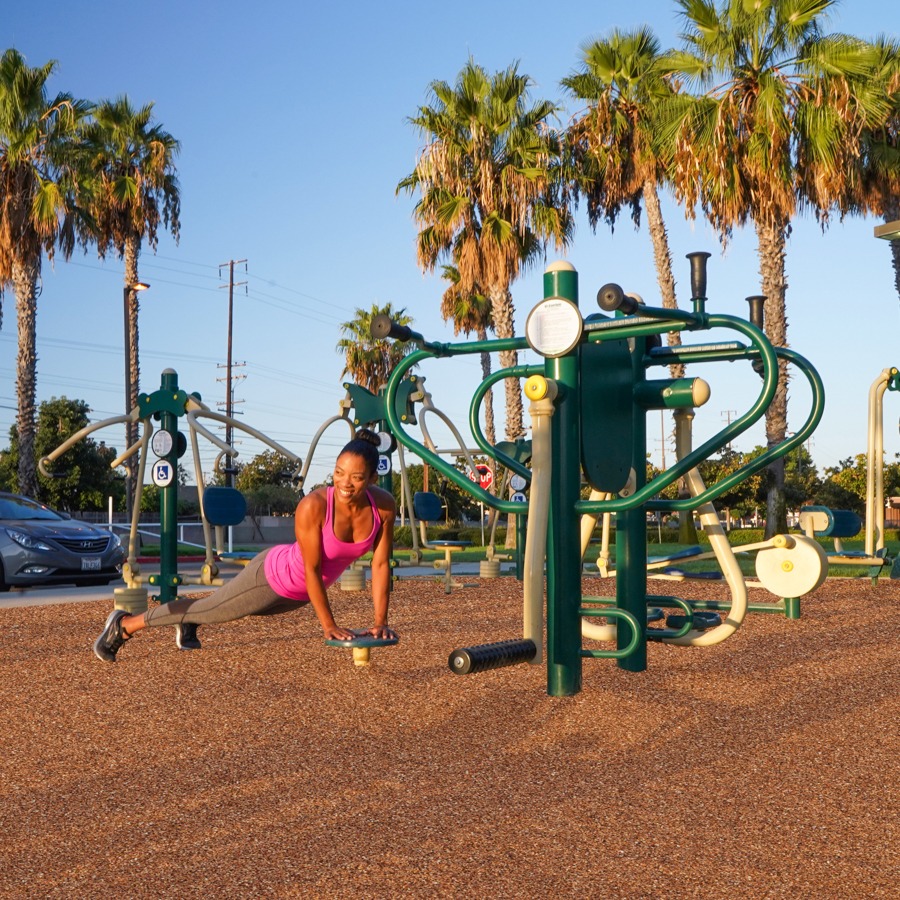 A woman exercising on a 4-Person Lower Body Combo