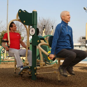 Two men using 2-person back and arms combo