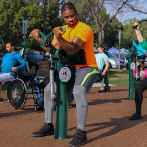 A man using the Arm Curl (adjustable resistance)