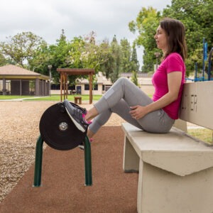 A woman using the recumbent bike (cycle only) while sitting on a bench