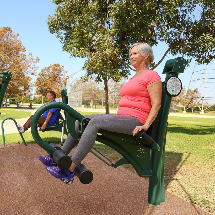 A woman using the adjustable leg extension and curl