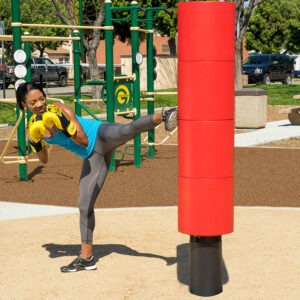 A woman kicking the kickboxing station