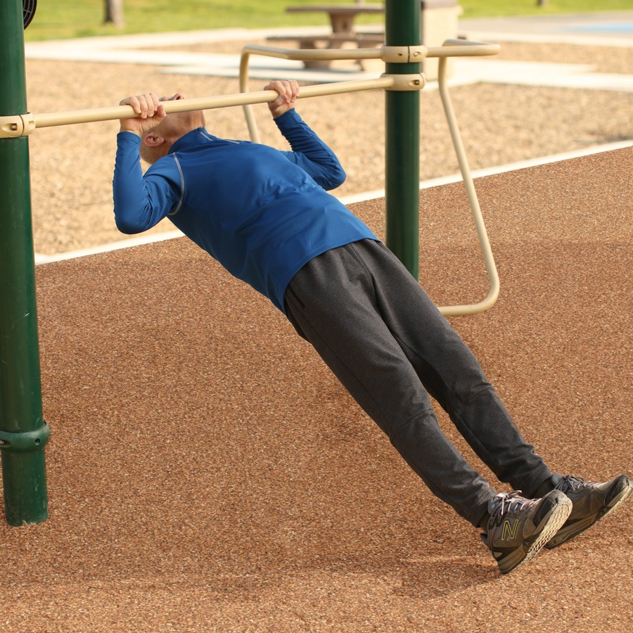 A man doing Assisted Pull Up on a Functional Fitness Rig