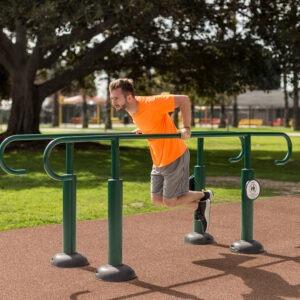 A man doing Dips on the Parallel Bars in a park