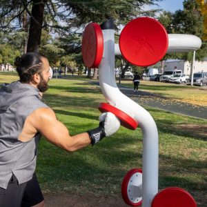 A man boxing on the Muay Thai Boxing Station in a park