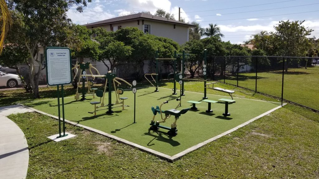 Outdoor fitness equipment at a park over turf