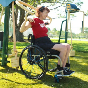 A woman in a wheelchair exercising on Accessible Vertical Press