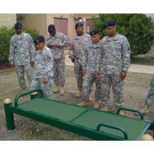 Soldiers standing near exercise bench