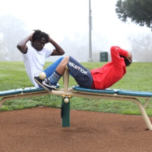 Two men using the 2-person incline sit up bench