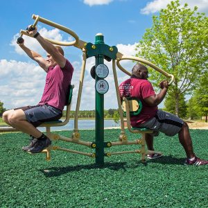 Two men exercising on the Vertical Press on a college campus