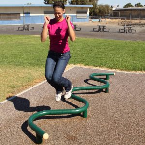 A woman jumping over s-shaped jump bar